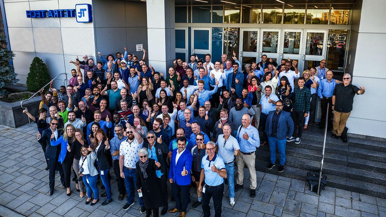 Large group of Tetra Tech employees in front of an office building